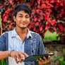 Sri Lankan teenager using digital tablet near Kandy, Sri Lanka (Ceylon).http://bhphoto.pl/IS/rajasthan_380.jpg